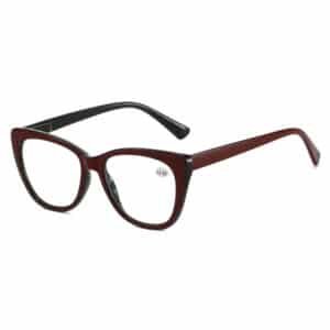A pair of red and black retro reading glasses in a classic cat-eye frame, featuring a +2.50 magnification sticker on the lens, set against a plain white background.