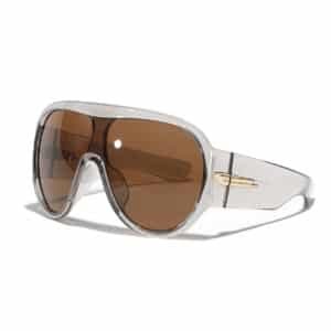 A pair of Oversized Shield Sunglasses featuring a transparent light grey frame, brown tinted lenses, and a gold-tone hardware accent on the temples, set against a solid white background.